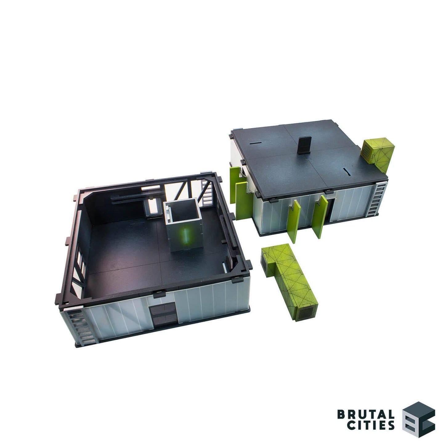two 28mm terrain sci fi buildings painted black with green detailing and translucent windows. roof removed from one building