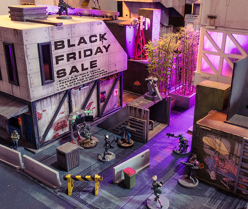 Cyberpunk terrain with miniatures and the words on the building reading 