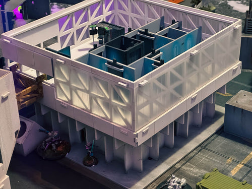 cyberpunk Tabletop terrain Model of a building structure with blue and white components on a city street background